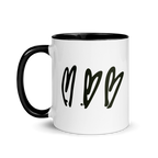 White mug with black interior and handle, featuring three black heart shapes on a white background