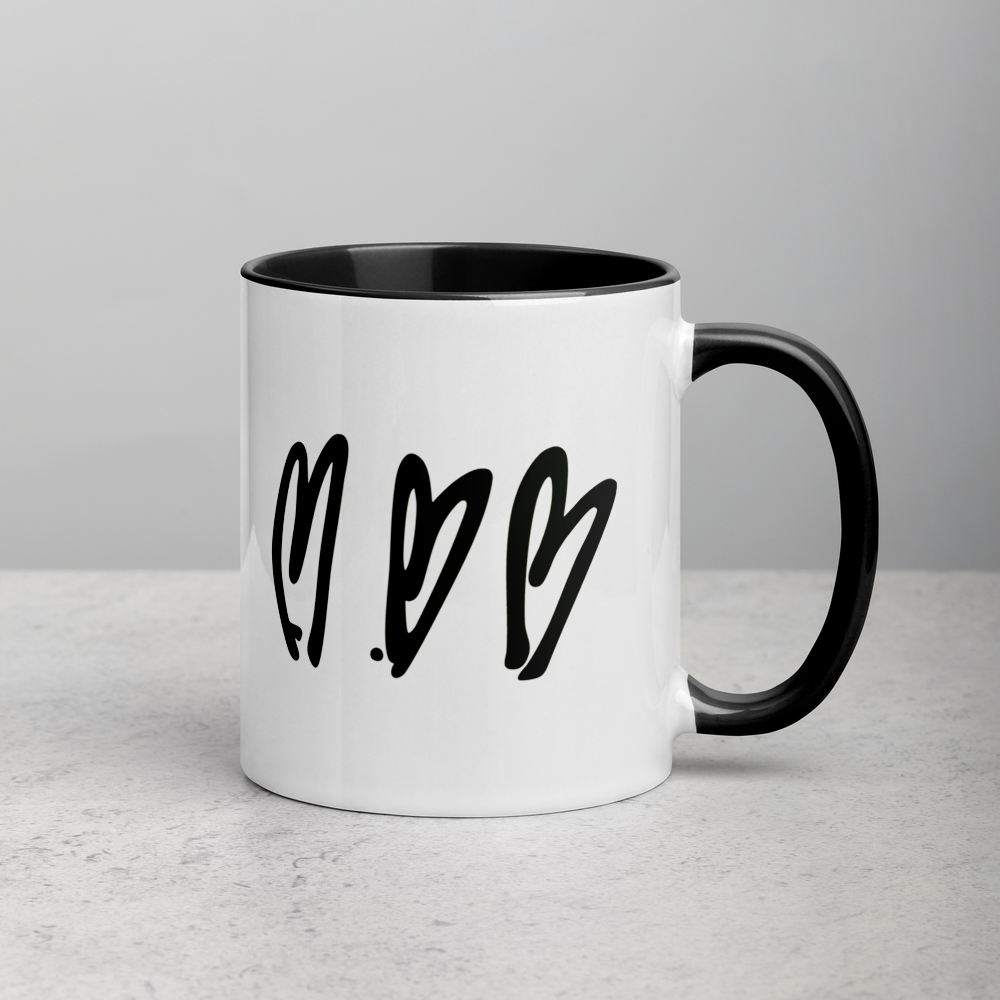 White mug with black interior and handle featuring three black heart shapes on a light gray background
