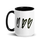 White mug with black interior, handle, and heart design on a white background